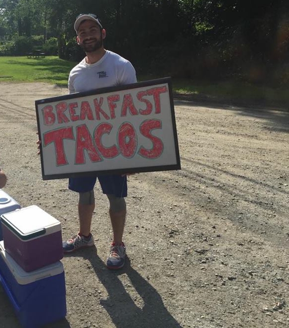 Tito with coolers full of breakfast tacos.