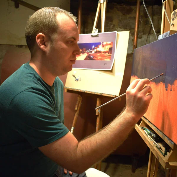 Patrick Seufert painting in his studio