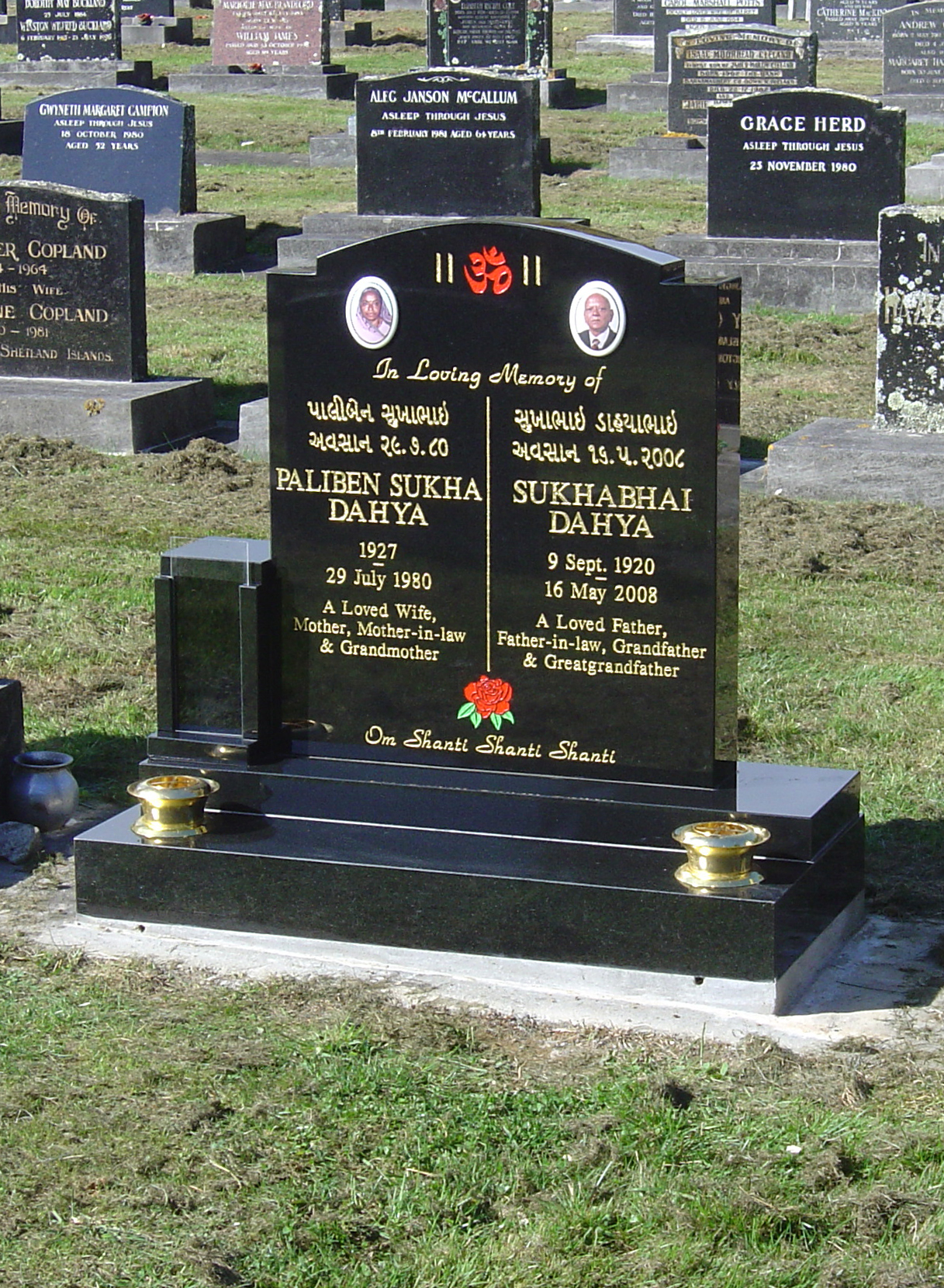 black headstone with gold lettering