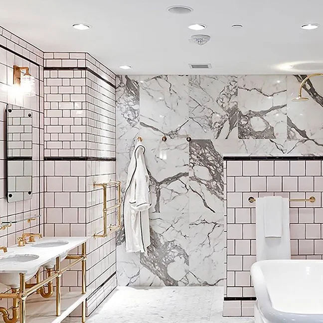 Expect the unexpected: Unlacquered brass gives a new spin to a black and white bath in our #Georgetown showroom. #ThePerfectBath