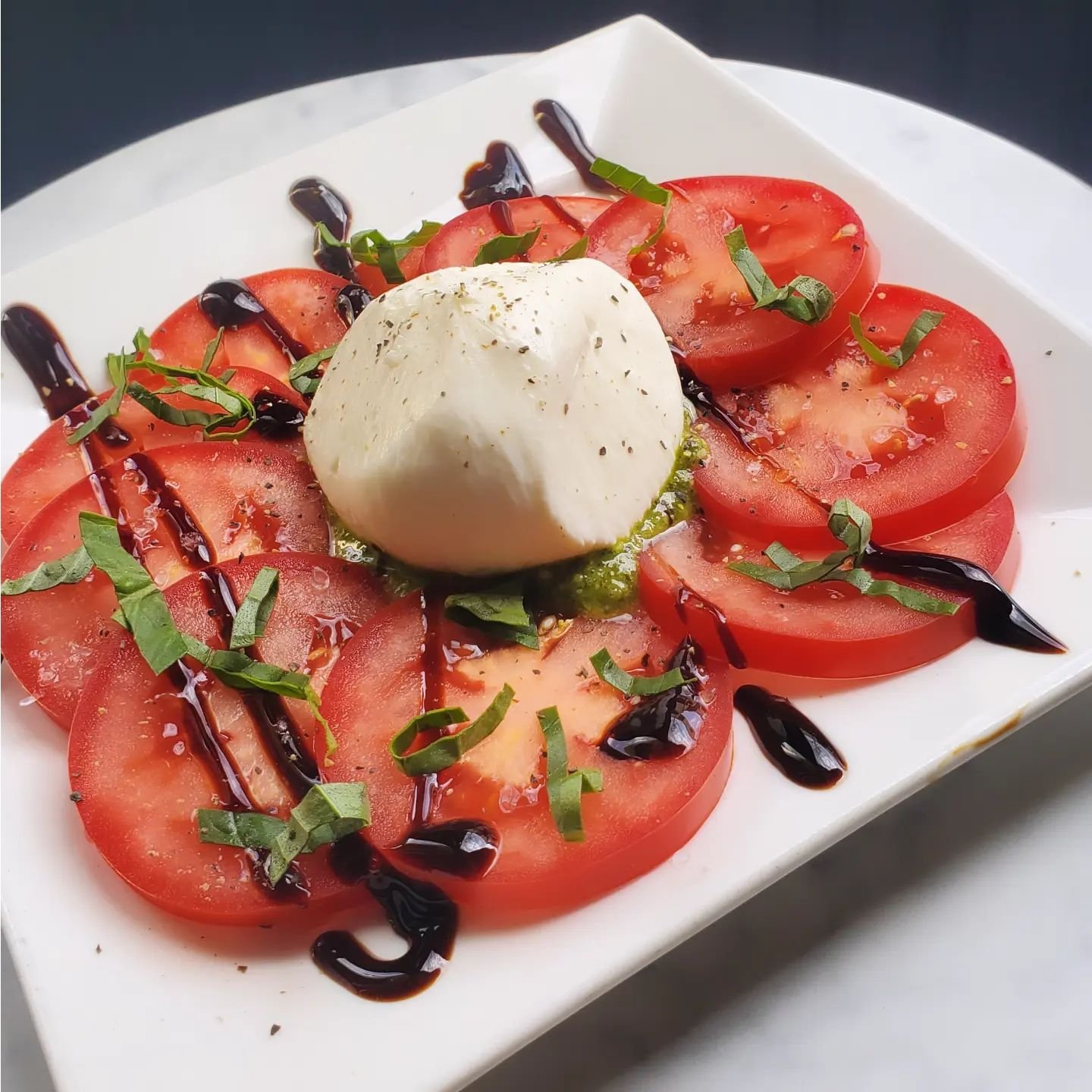 The perfect, sit in the sun hors d'oeuvre! 
🍅 Burrata, basil, tomato, pesto, balsamic 🍅