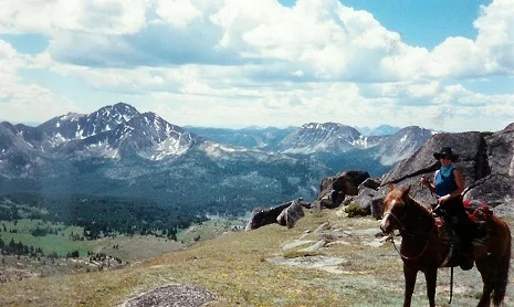 Snoopy and me on the top of the world. I rode Snoopy for years, after the guests left camp I would turn him loose and he'd come in the tent and eat pancakes with me!