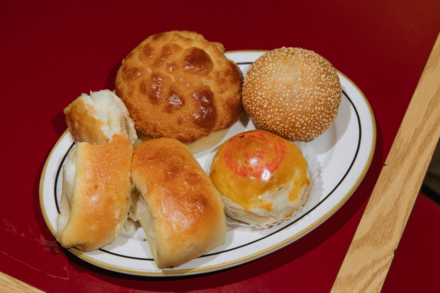  An assortment: pineapple bun, coconut bun (aka cocktail bun), red bean pastry and sesame ball 