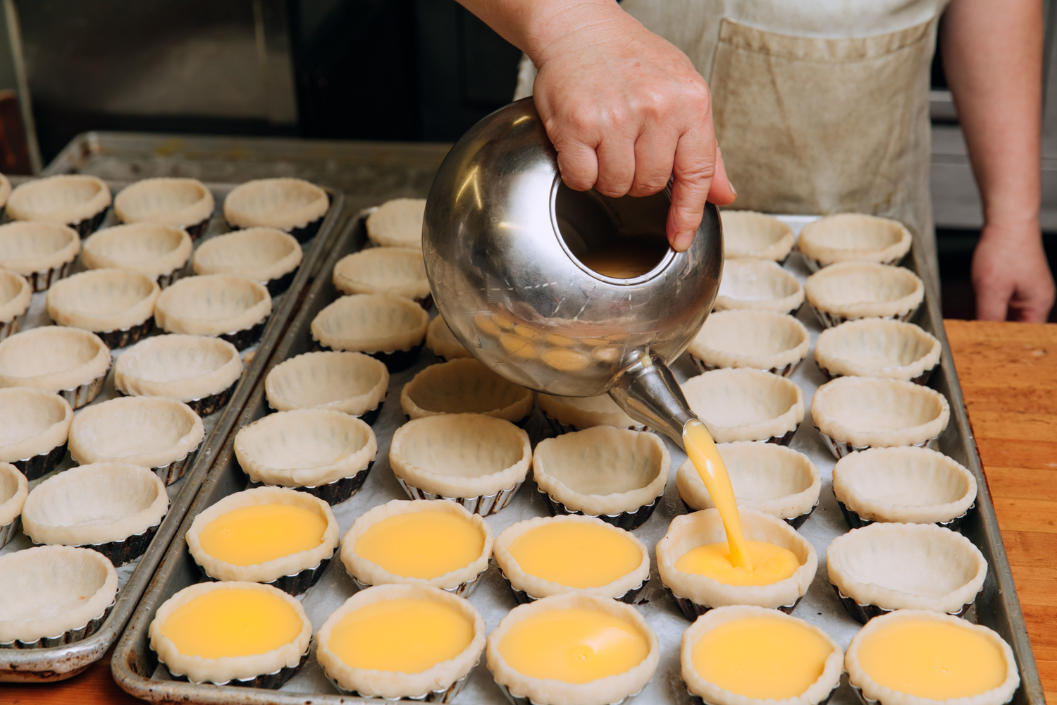  Hundreds of dan tat (egg custard) are made daily at AA Bakery &amp; Cafe. 