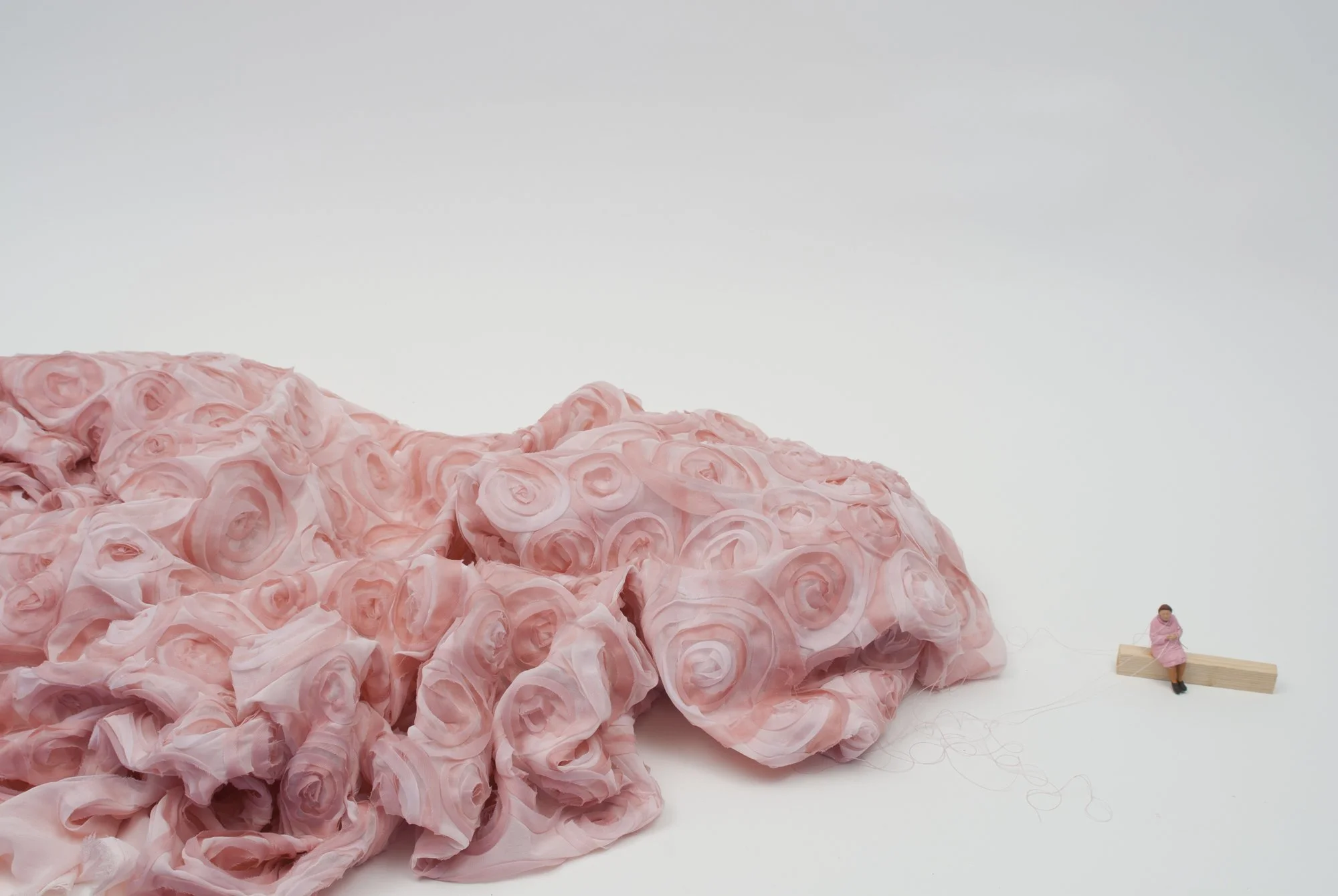 Tejedora (2017)  Fabric and figurine on wooden base with pink string  dimensions variable 