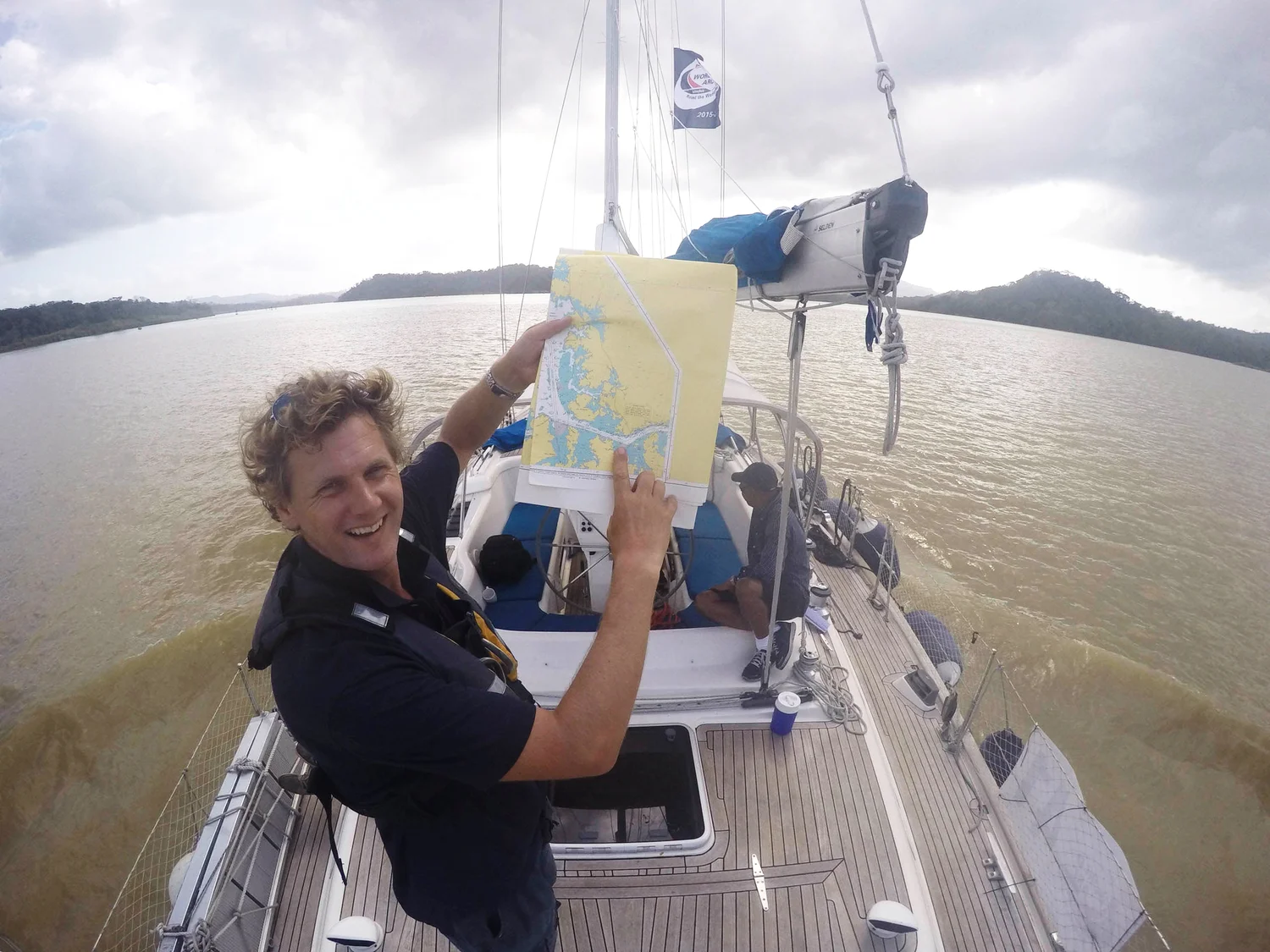Caspar on deck with a chart, sailing with his family
