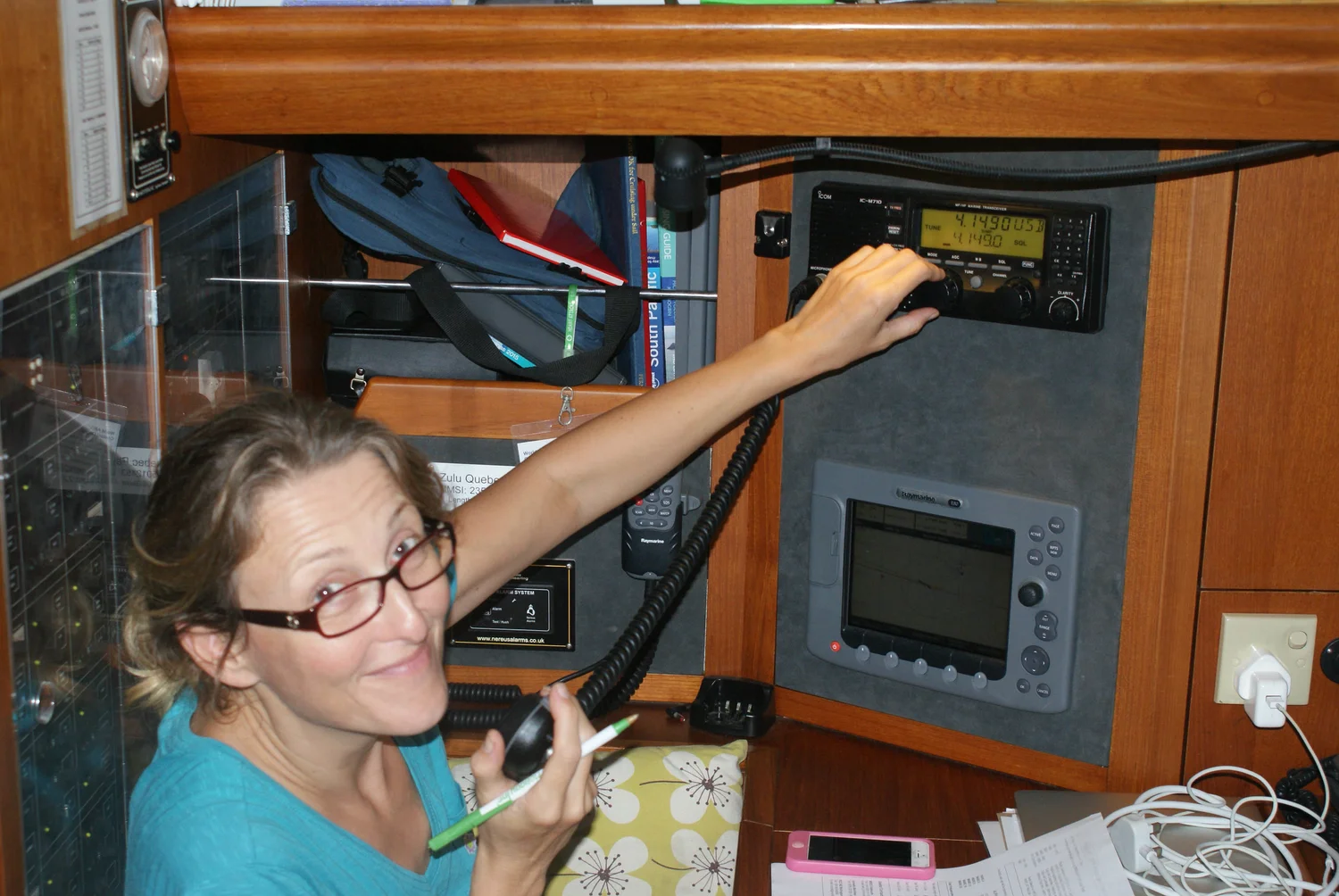 At the chart table, checking the radio and instruments