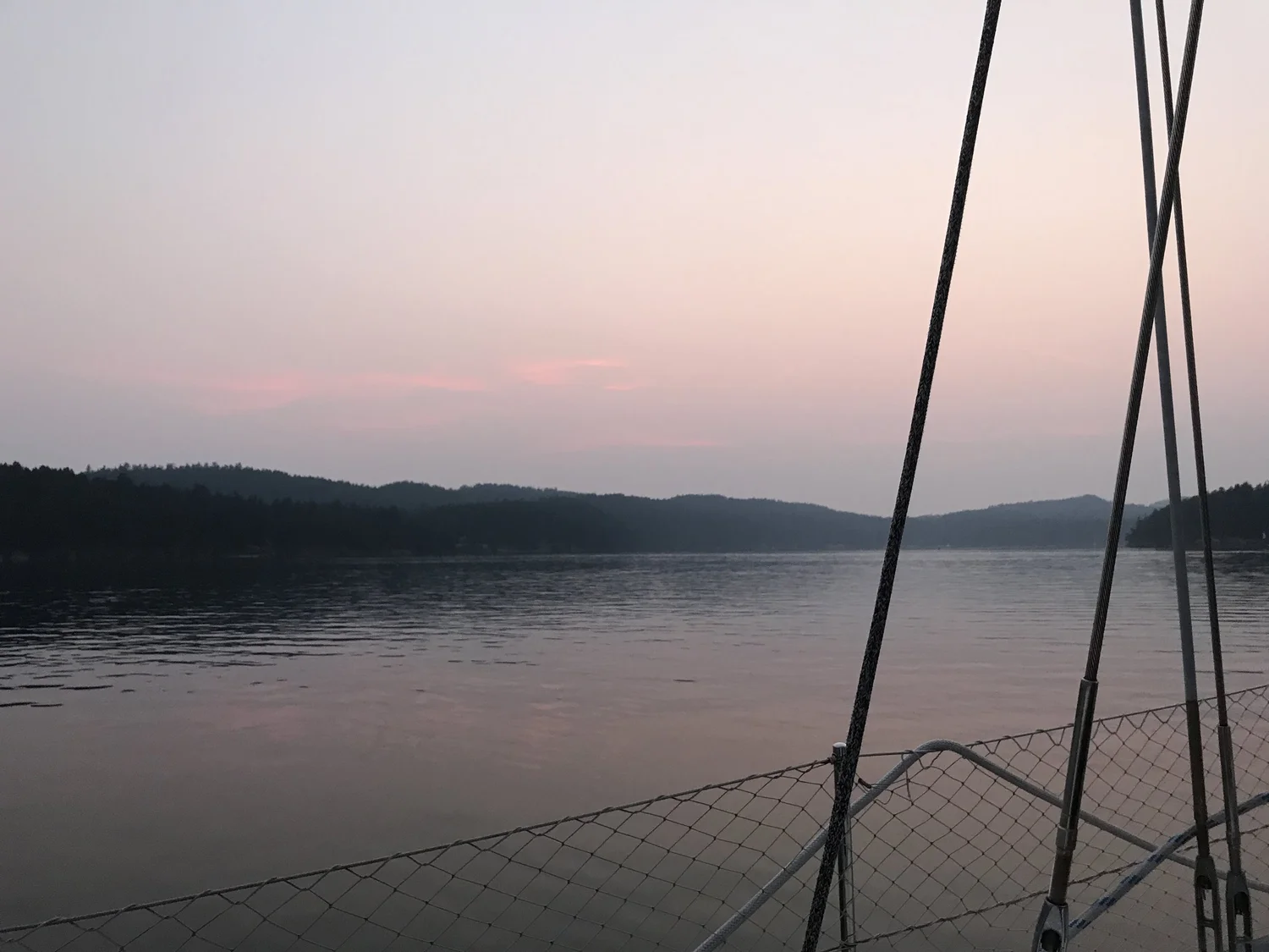Calm water at sunset seen from a yacht