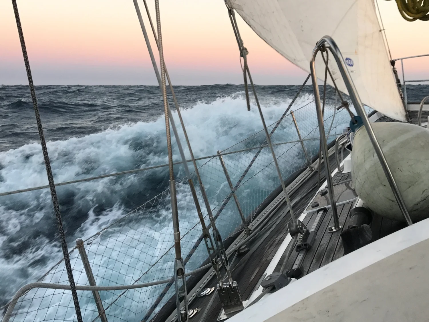 A yacht driving through rough seas