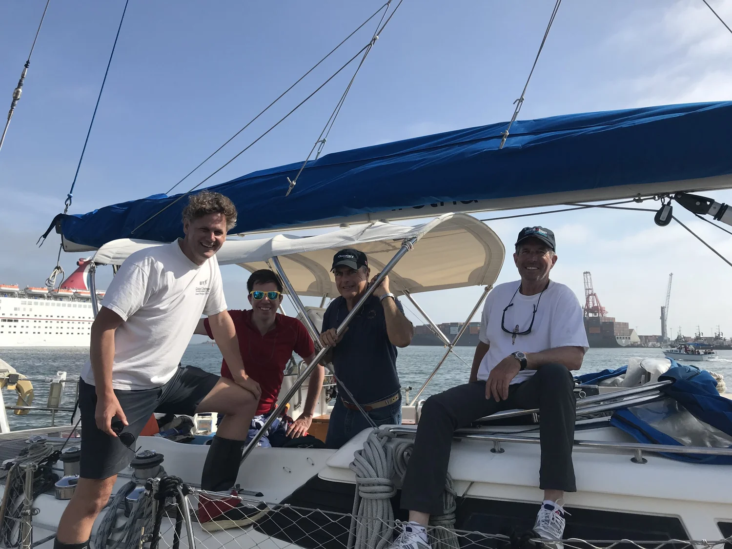 Crew sitting together on the deck of a yacht