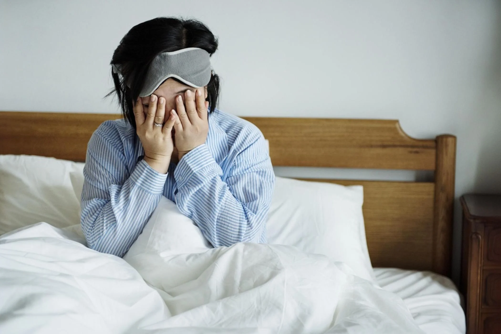 woman waking up to consider hormone replacement therapy