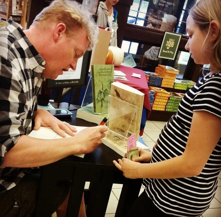 Andrew Heller signs a copy of his YA fiction book for a young reader a Barnes and Noble author event in Salisbury, Maryland. Click this image to see his books at B&N!