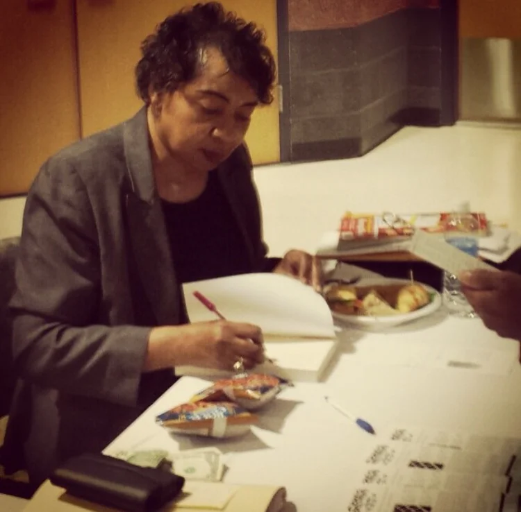 Clara Small signs copies of Compass Points after a lecture at Wor-Wic Community College.