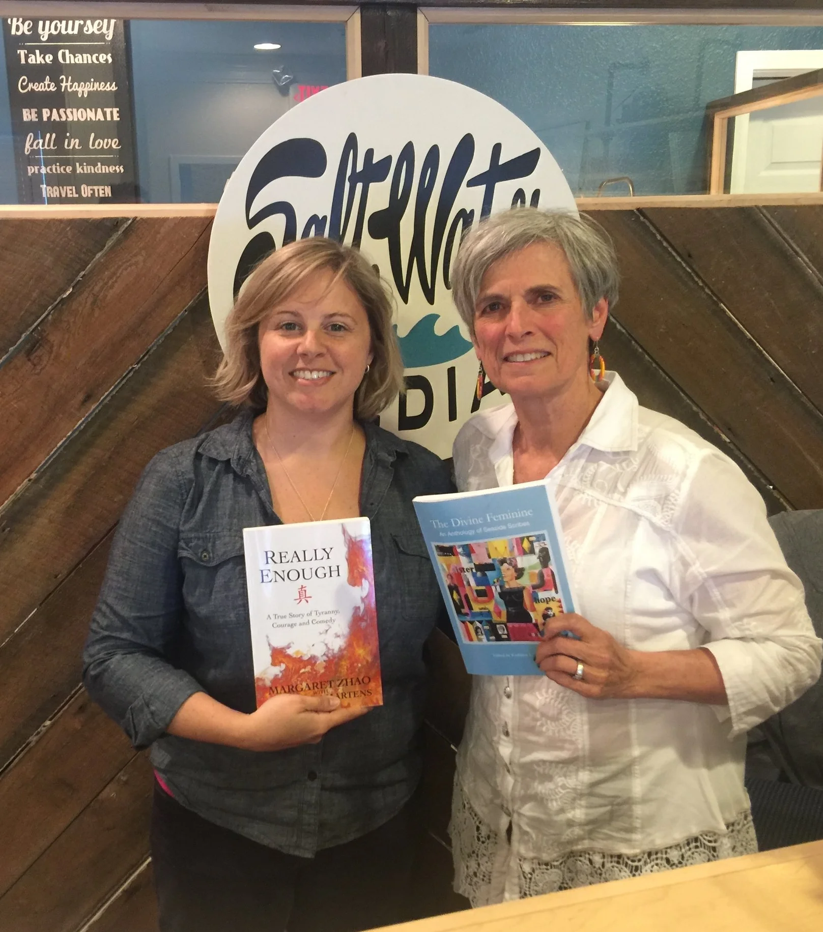 Stephanie shows off a copy of Really Enough, the memoir of Margaret Zhao, co-authored by Kathleen while Kathleen reveals The Divine Feminine .