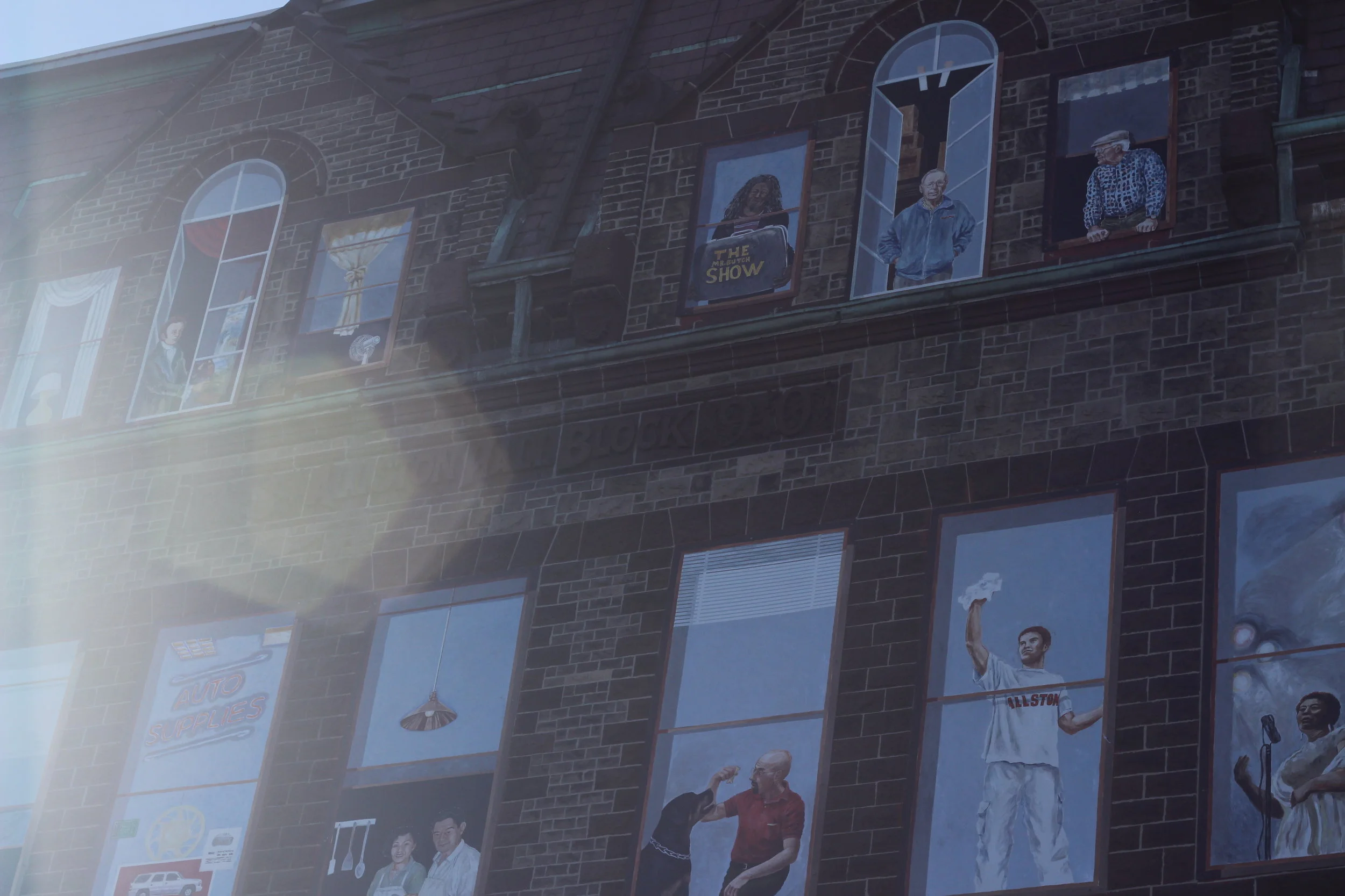 Painted residents of Allston greet the world from their faux windows.