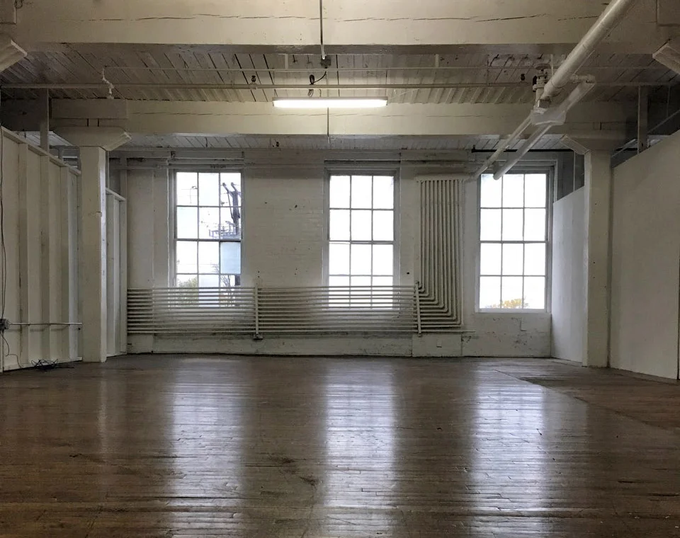 One of our empty studio spaces with north light windows, hardwood floors, high ceilings and a funky artistic vibe!