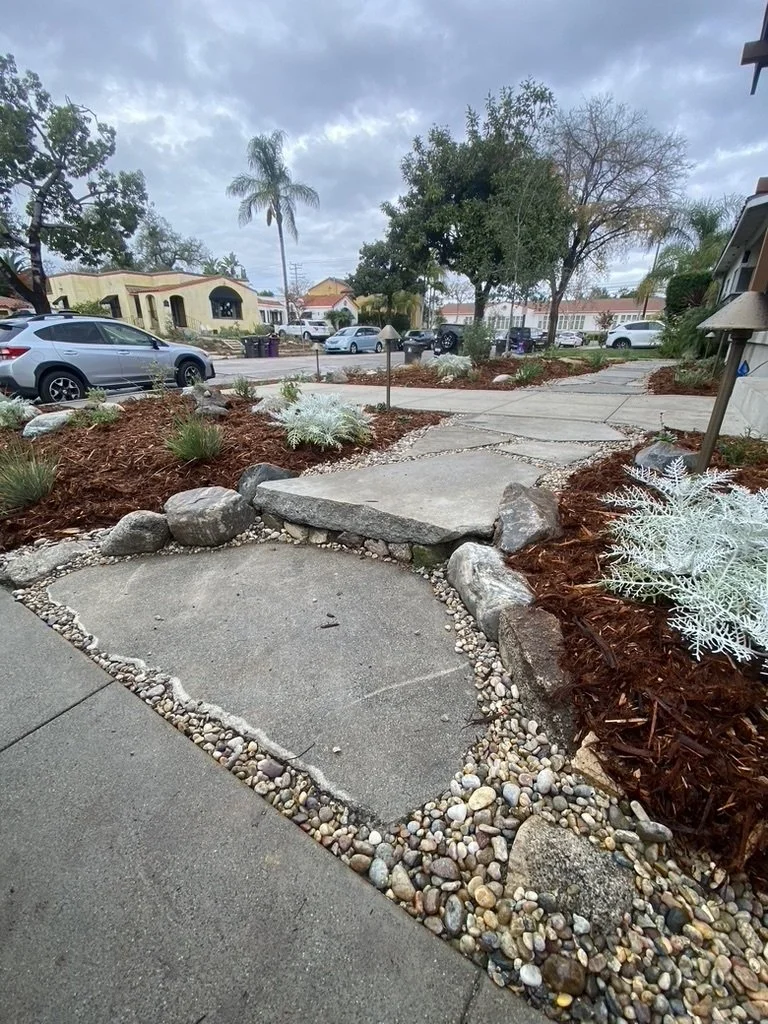 Salvaged concrete removed from this property were repurposed to create flagstone-like steppers and risers.