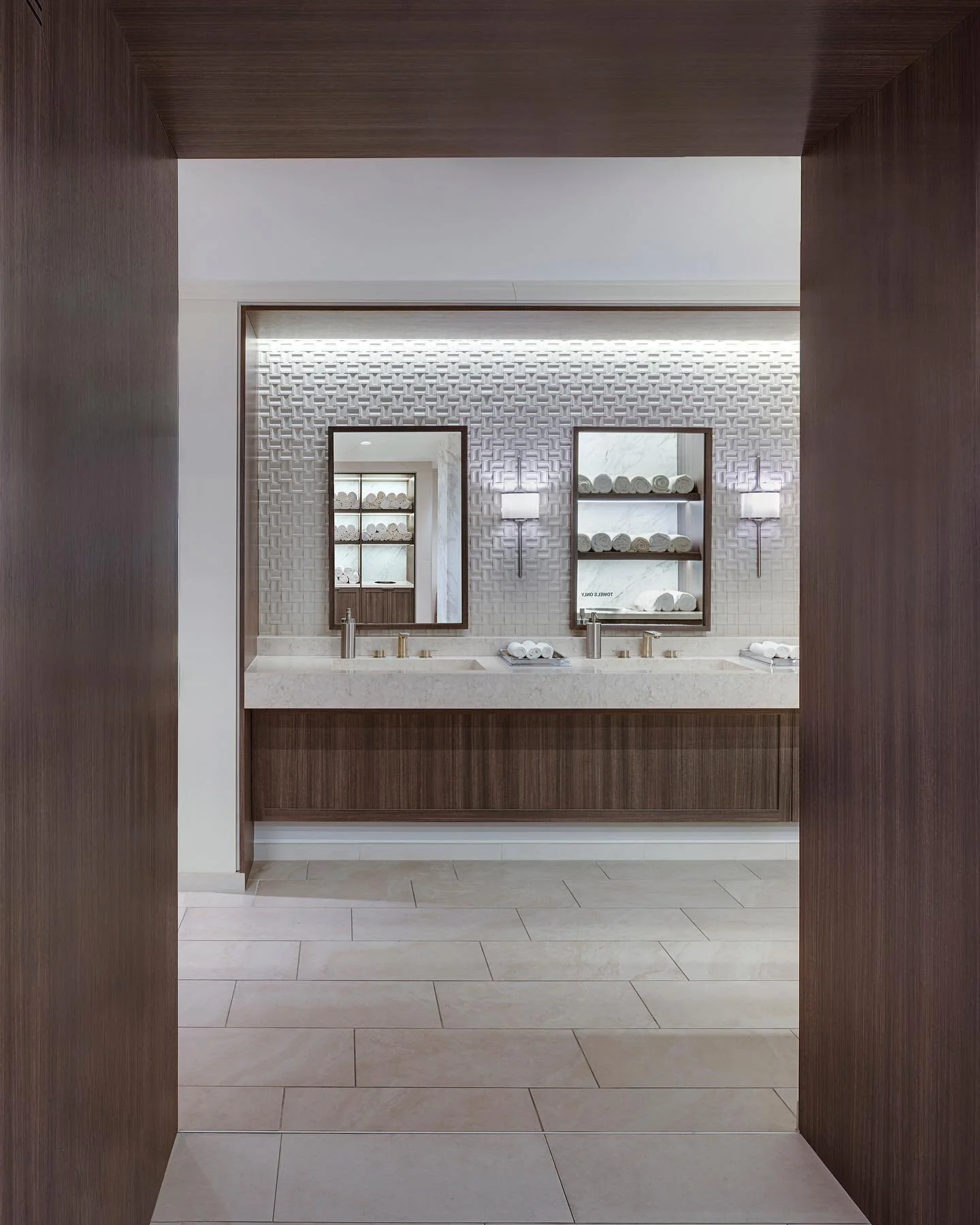 Continuing our week of locker rooms, this is a more contemporary, high-contrast take on wet areas. With a dark portal and light flooring, this space is a high-end retreat for its members. // #architecture #design #lockerroom #club #hospitality #inter