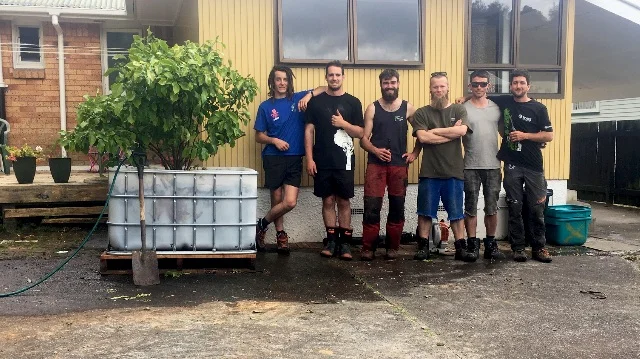 A few volunteers helping a local family transplant a very special tree.