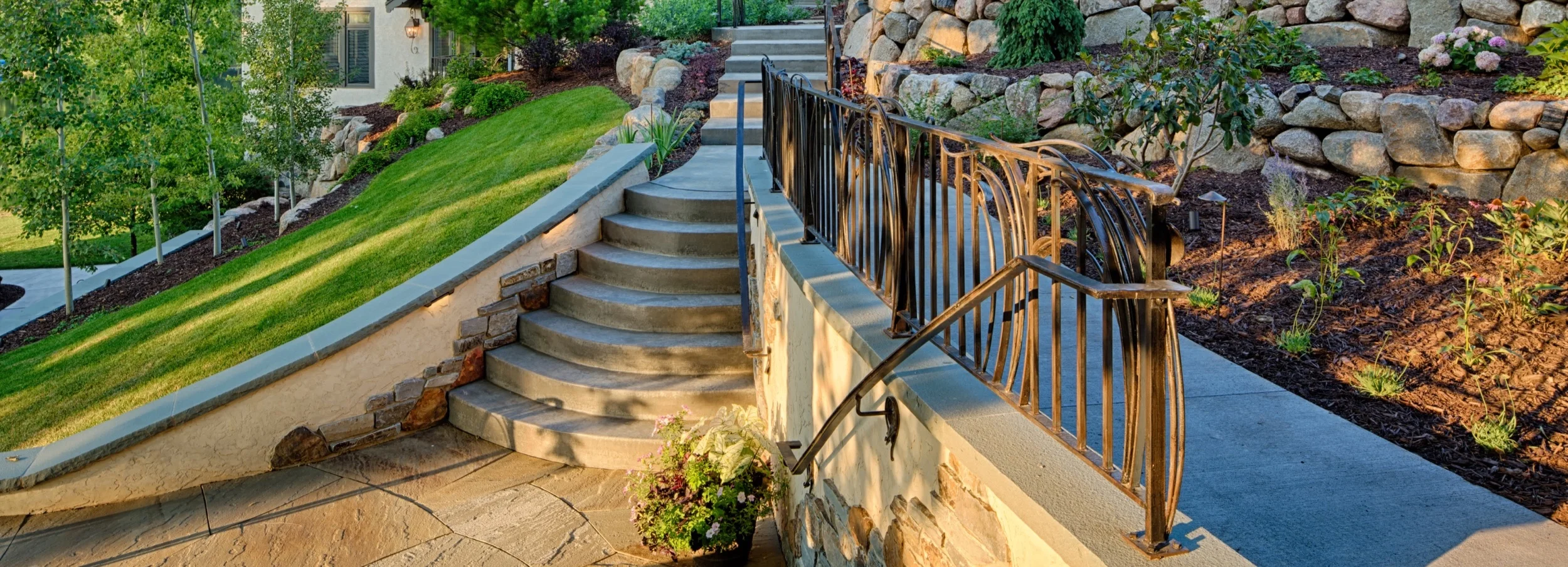 Multi-colored fieldstone façade enhances look of old stucco retaining wall