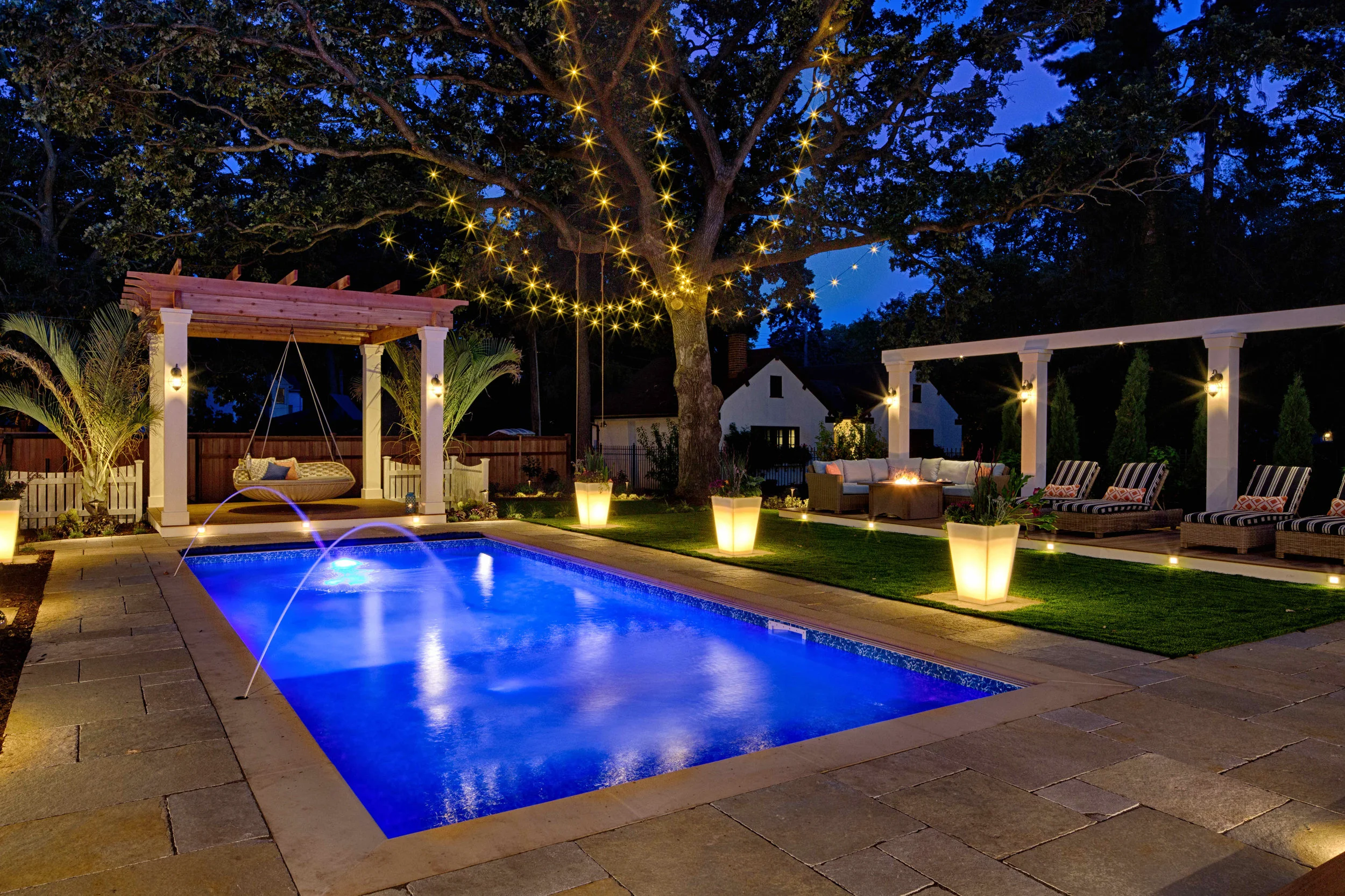 Laminar jets with LED lights shoot water into brilliant blue pool.