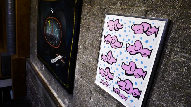 Photo of a framed "Pink Puppyfish" print at the "Creatures from the Deep" exhibit at 225 Forest Gallery. To the left of the print is an original painting by Anne Faith Nicholls.
