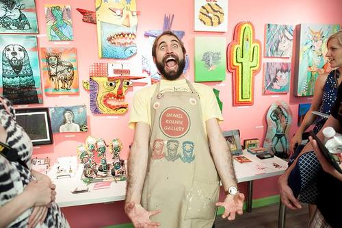 Daniel Rolnik (c) wearing the apron at the opening reception of "Girl Scouts & Adventure Guides" (Aug 2015) - with male nipple stickers by Micol Hebron.