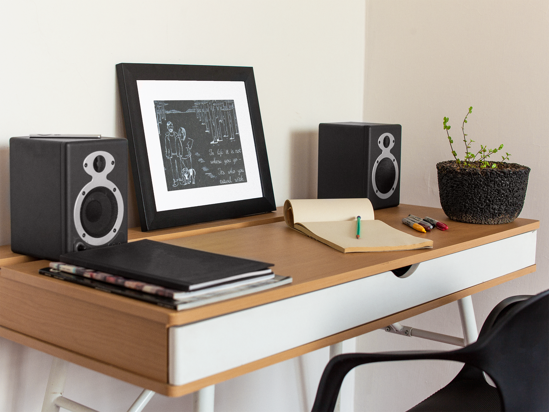 art-print-mockup-on-a-black-frame-lying-on-a-wooden-desk-near-speakers-a14691.png