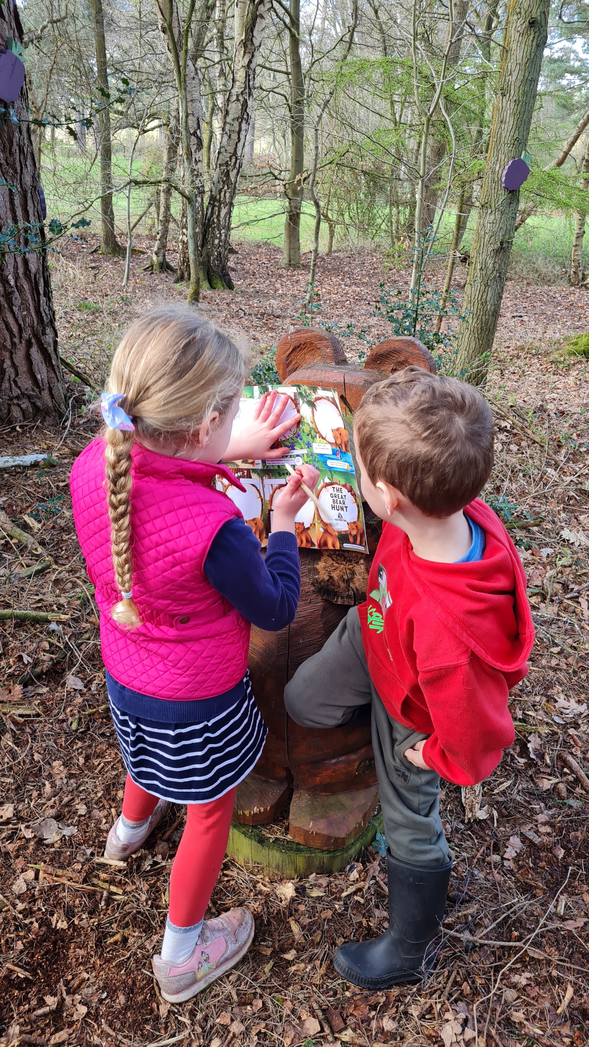 young children discovering a bear