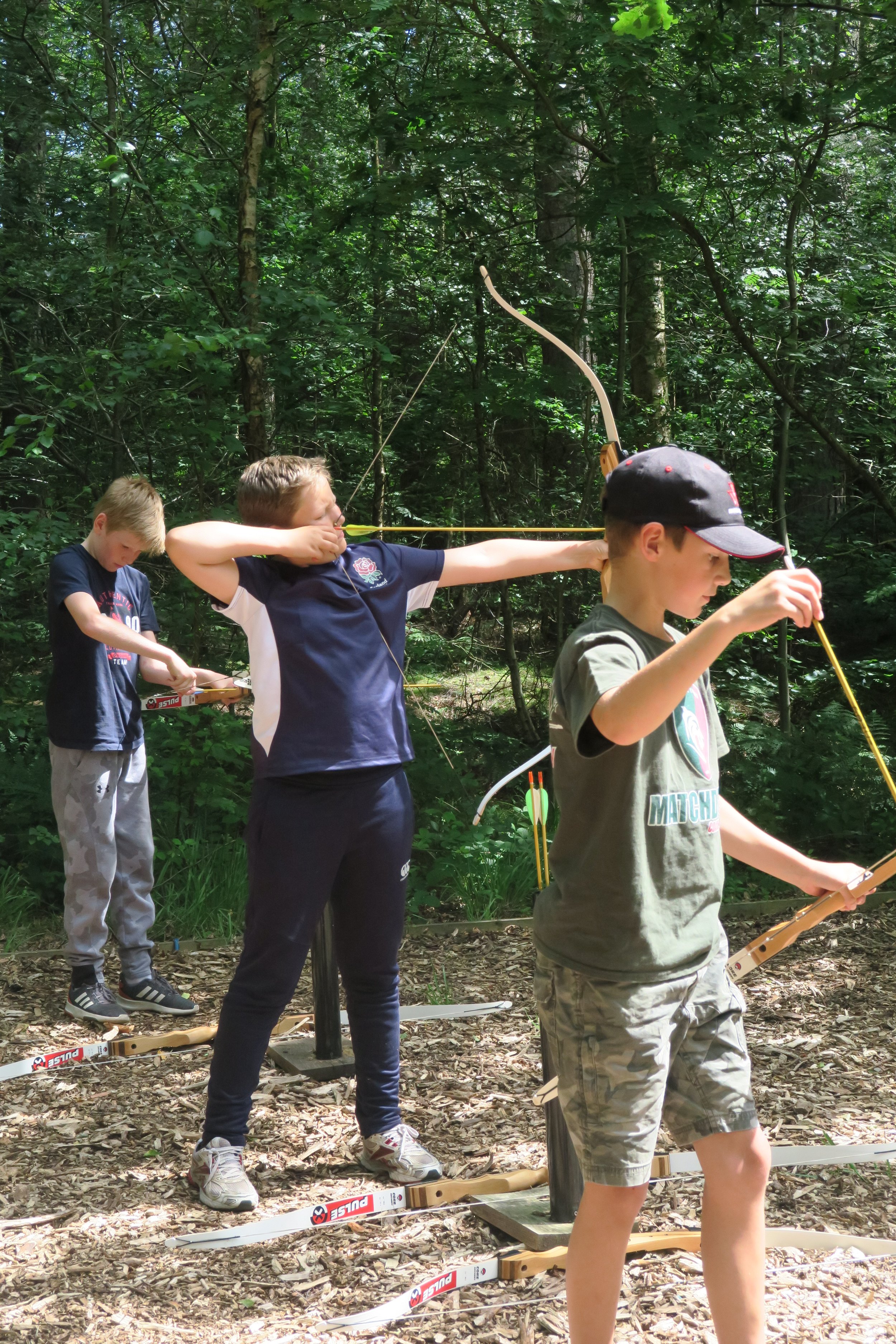 group of children on an archery range firing