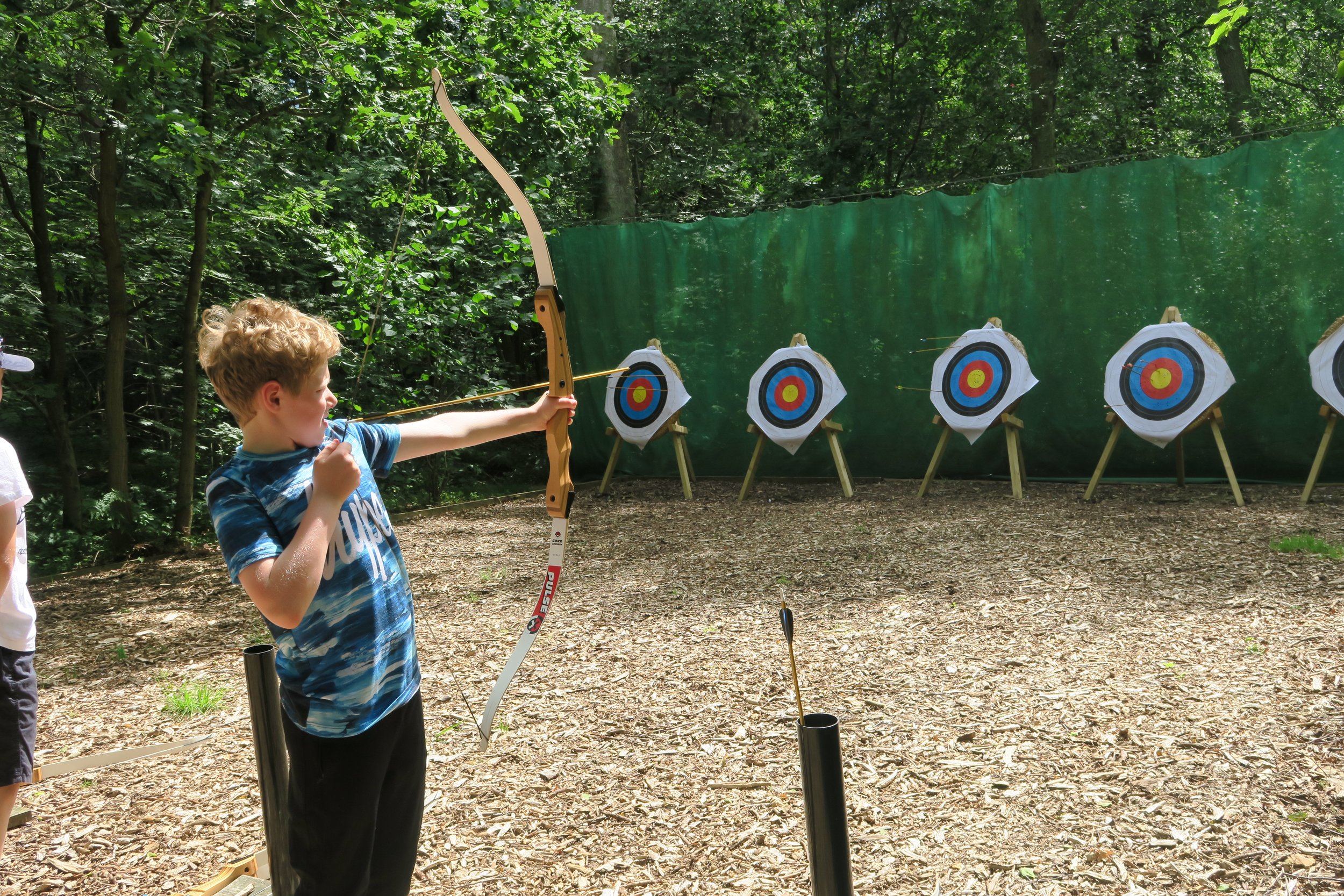 boy firing an arrow at a target