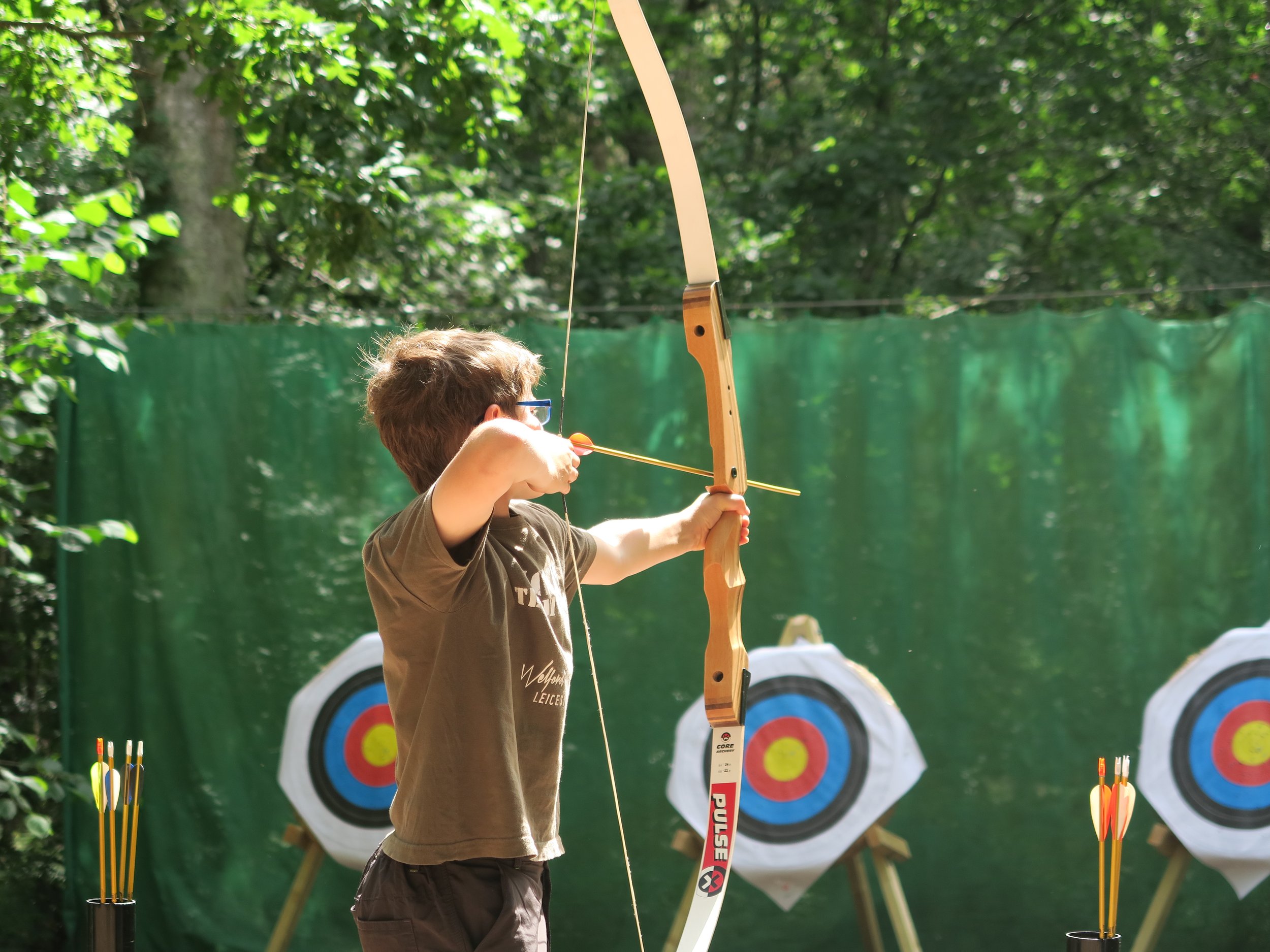 Boy firing an arrow for a bullseye