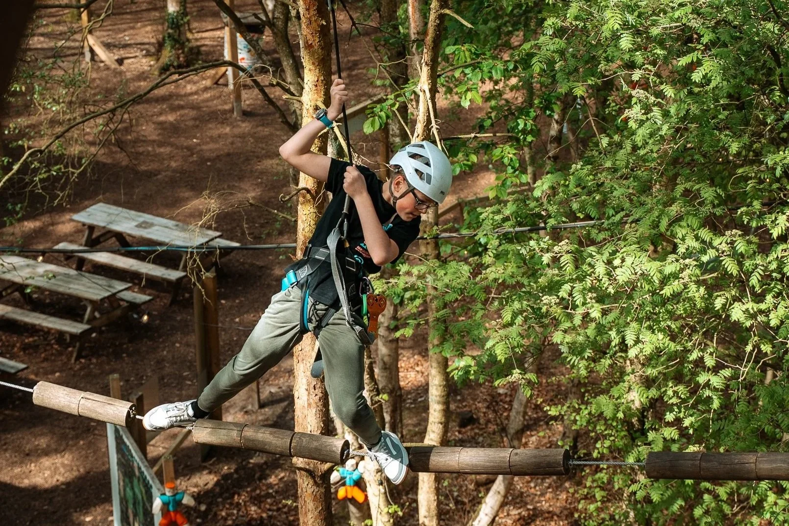 Boarding school group taking part in outdoor team challenges