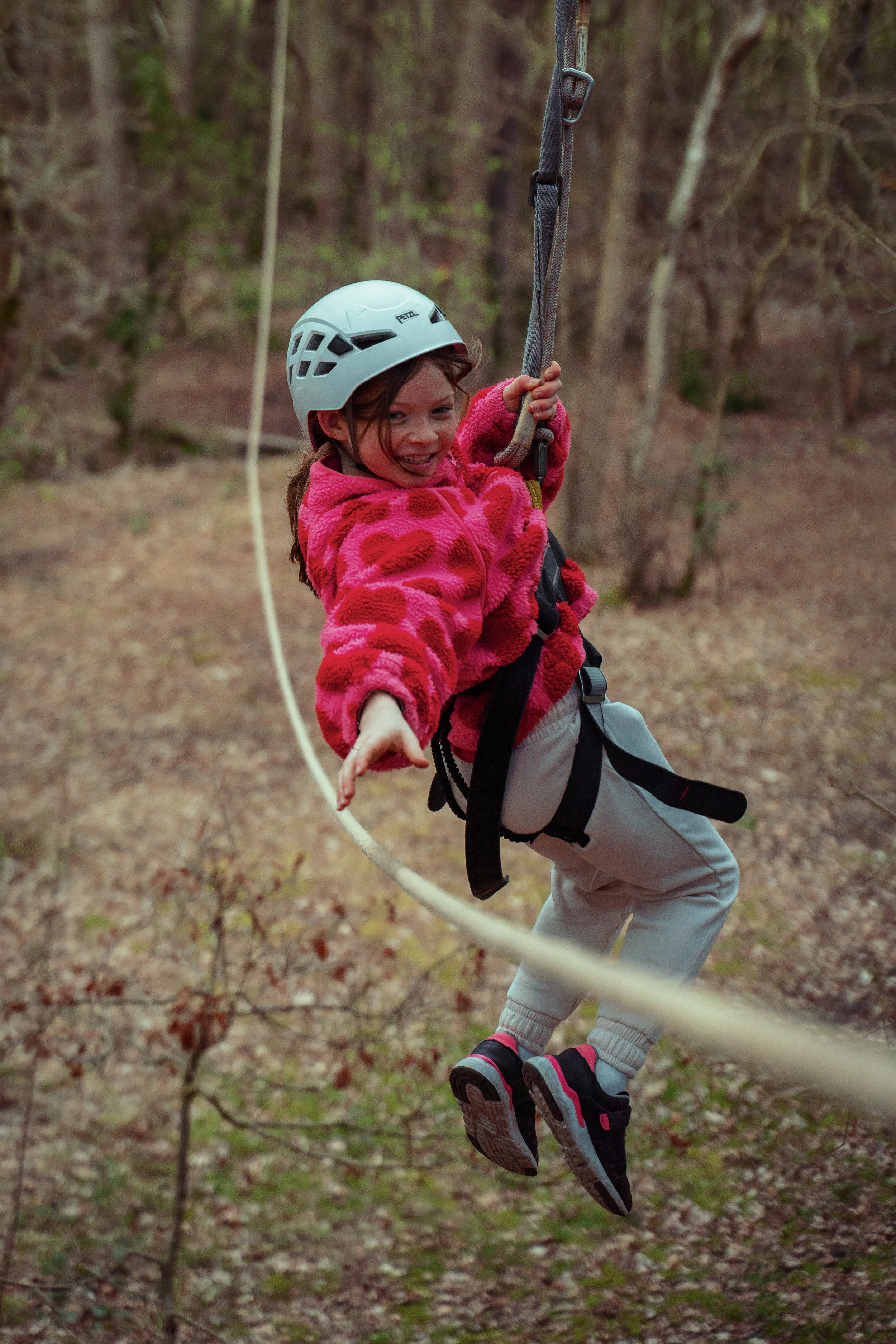 Children riding zip lines during a home education group visit