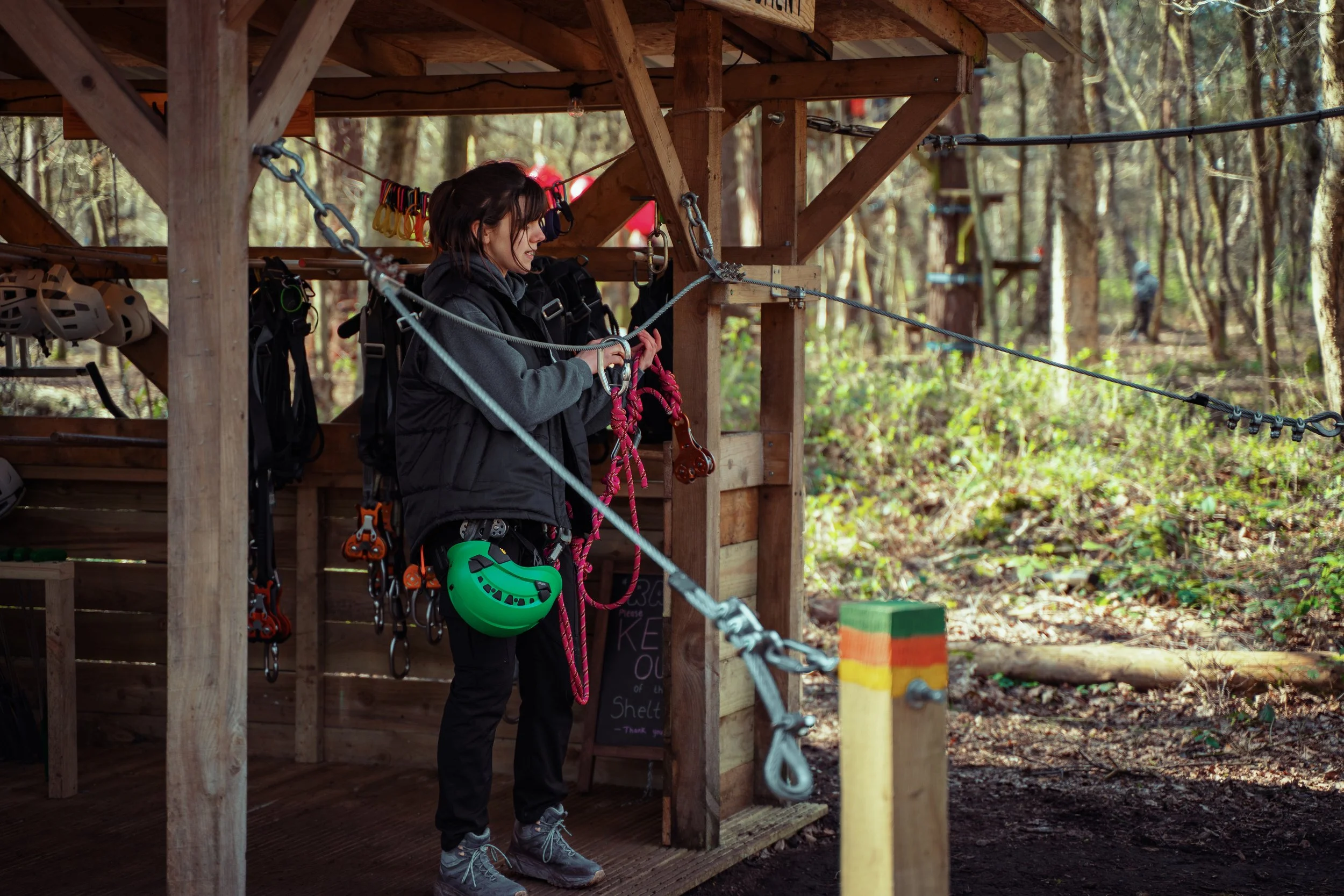 Instructor supporting a mixed-age group on the ropes course