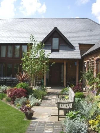 Although technically an extension to a small cottage, this in essence is a new dwelling in an Oxfordshire village where development is strictly controlled. Traditional in appearance, it encompasses many ecological features including ground source heating.