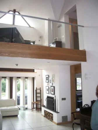 Interior view of above, comprising a double height gallery with a "bridge" linking different rooms on the first floor. Both ground and first floor rooms have underfloor heating throughout.