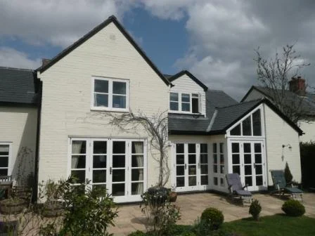 The solution involved re-orientating the sitting room and extending principally at ground floor level to form a large, light kitchen/living/breakfast room with a master bedroom and en-suite bathroom above a new boot-room.