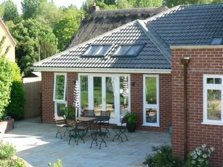This relatively simple single storey extension with a vaulted ceiling provides plentiful natural light for the owner's artist studio.