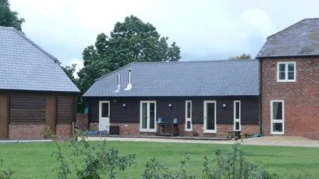 This agricultural building was in a state of dilapidation, but nevertheless worthy of retention and was conserved by using a system of props and only re-constructing brickwork where absolutely necessary. It forms the kitchen, breakfast and family area of a larger converted barn