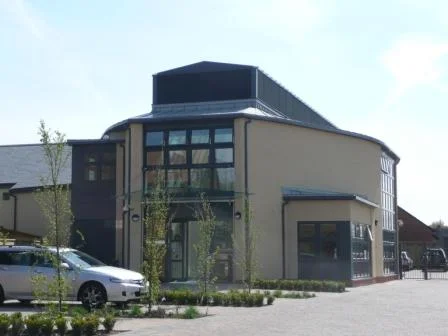 Self-contained accommodation for twelve residents & carers, and a main communal building (photo), incorporating social, medical, welfare and physiotherapy facilities, for the Injured Jockeys Fund.