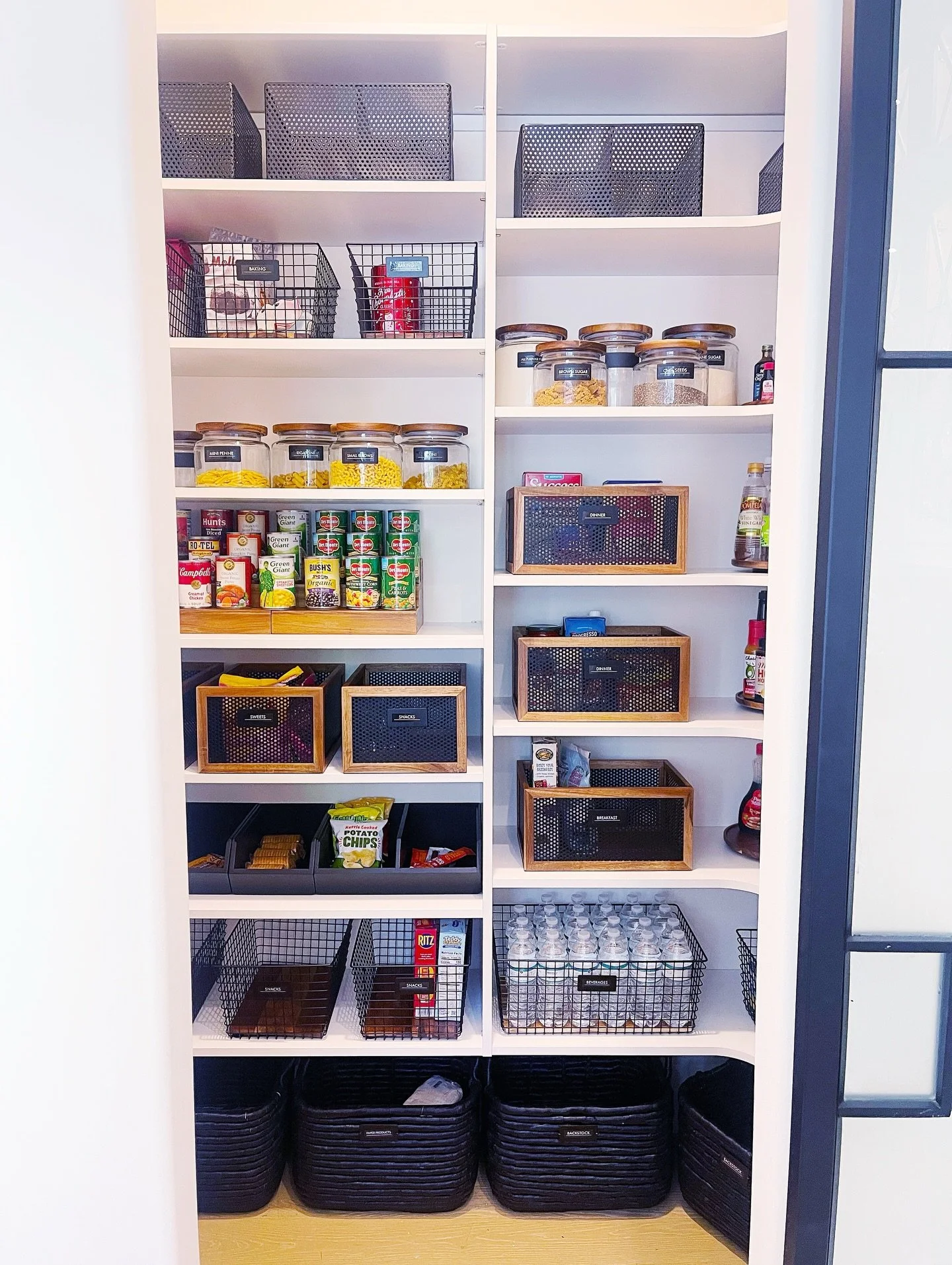 PAINT IT BLACK⁣
⁣
We will forever love a black and neutral wood pantry. 🖤🤍⁣
⁣
⁣
⁣
⁣
⁣
Luxury home organizing in Atlanta designed to transform your home into a calm, elevated and intentional space. #organizer #atlanta #homeorganizing