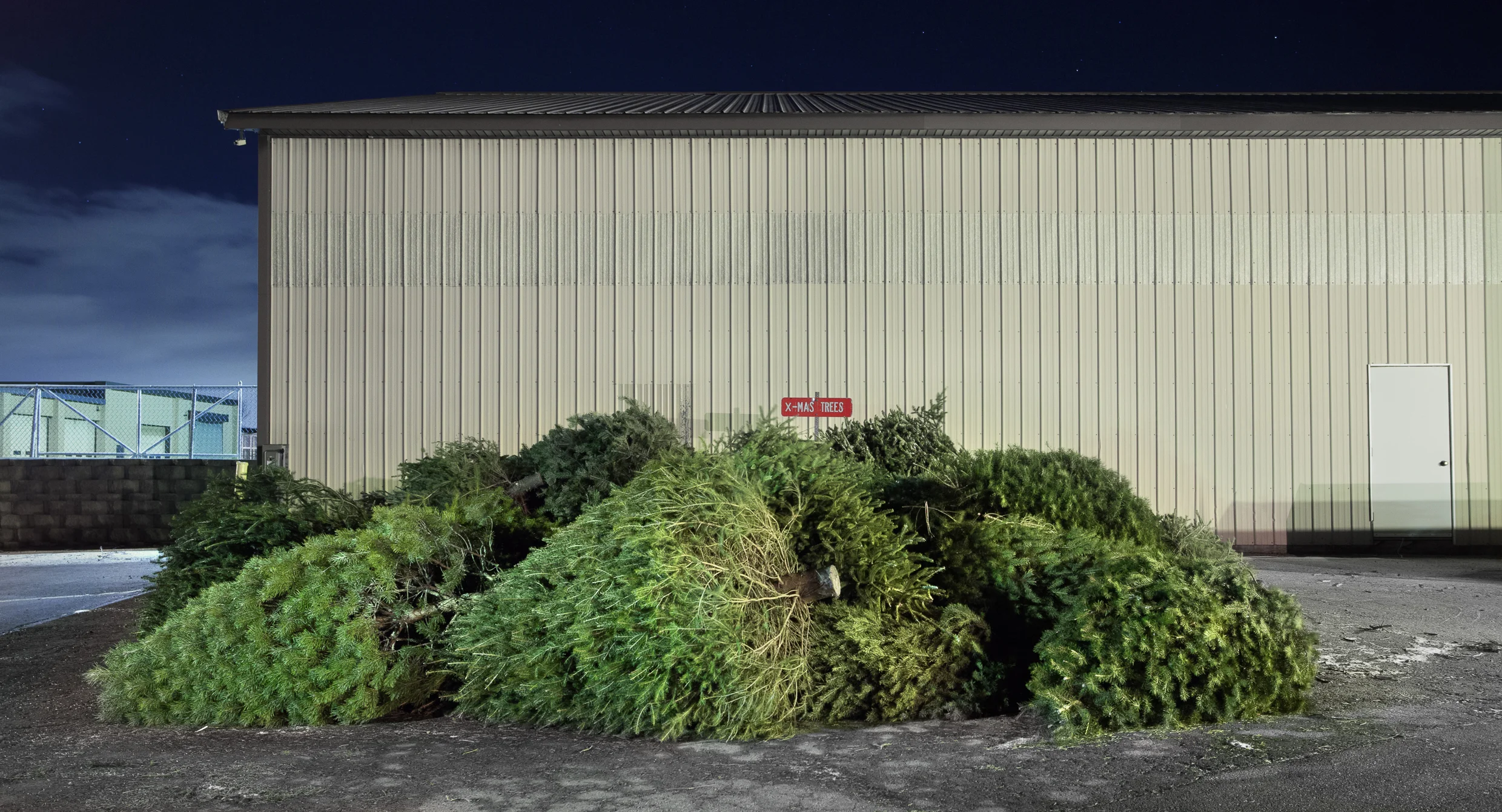 Authentic trees have become synonymous with the idea of a quintessential holiday. However, as a commodity that consumers have very little connection to the production and life cycle of, holiday trees stand as an symbol of modern consumerism. Most trees grow for seven to ten years before they are sent to market, and once it has played its part in the tradition, the tree loses its symbolic value and is discarded after a few weeks. By focusing on the repetition of this motif, this series seeks to assemble a greater picture of mass consumption. View this gallery as a grid