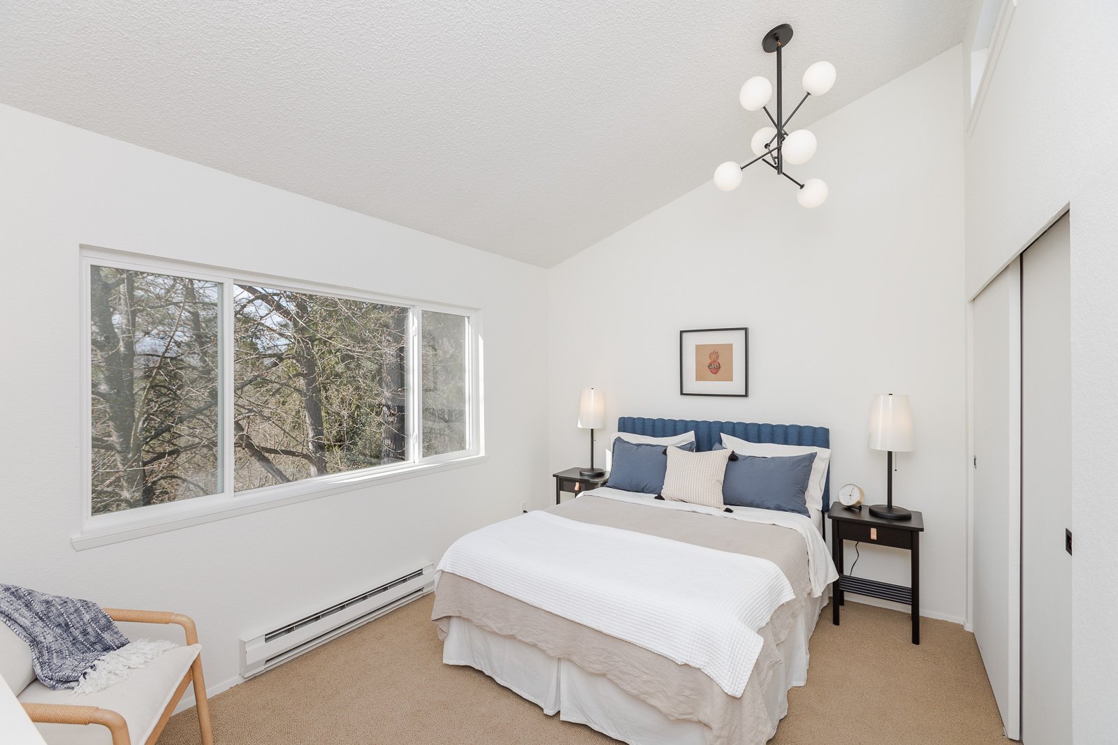  Modern light fixtures throughout. Bedroom #1 of 2 is spacious and large, nature-facing windows.    