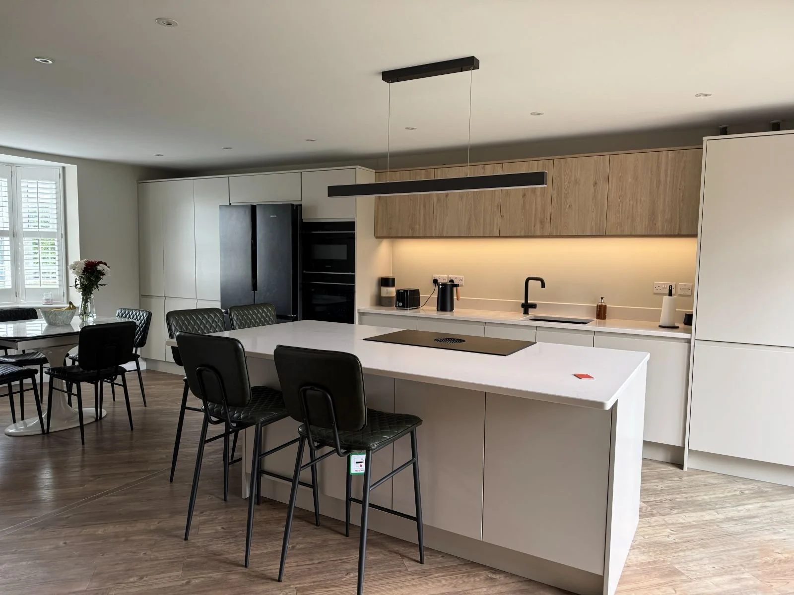 A sleek, modern handleless kitchen design and installation by Rose Kitchens in burton on trent 