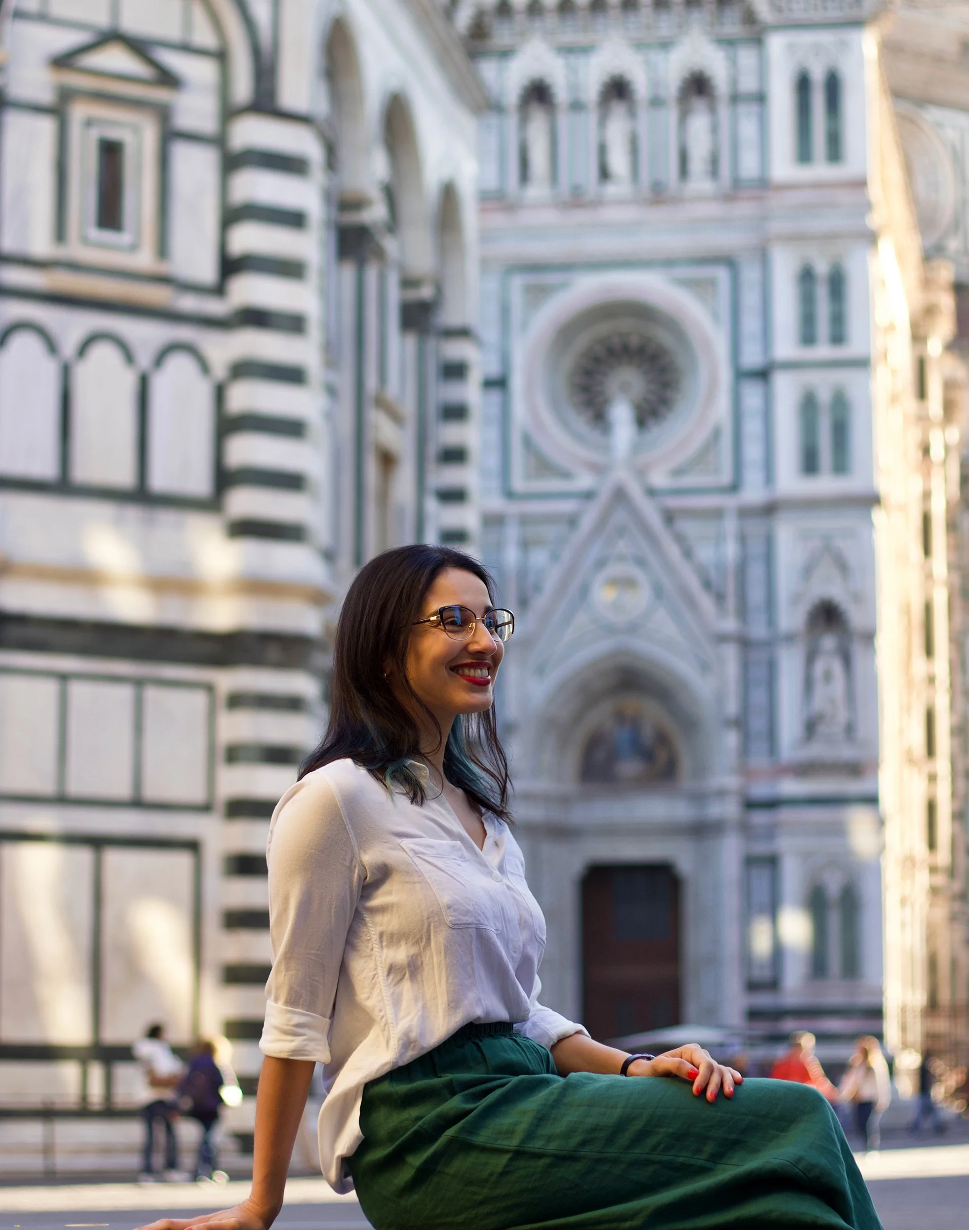 Jade sitting on a bench in front of the cathedral in Florence