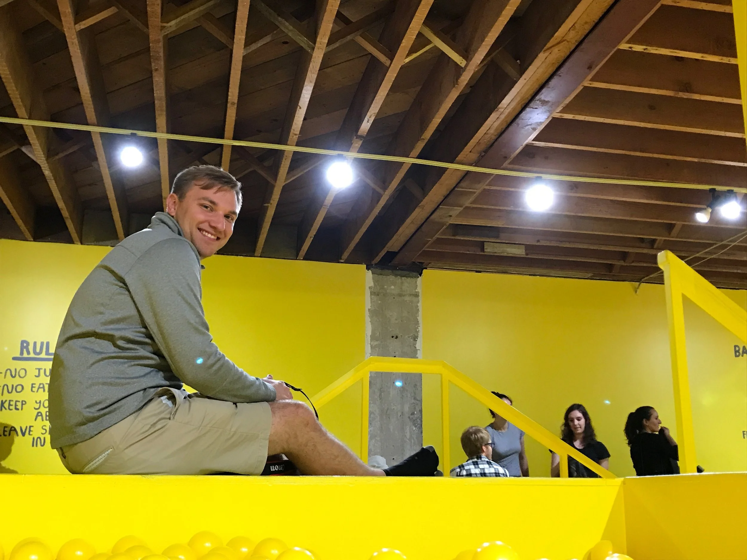 Vince playing lifeguard in the ball pit.
