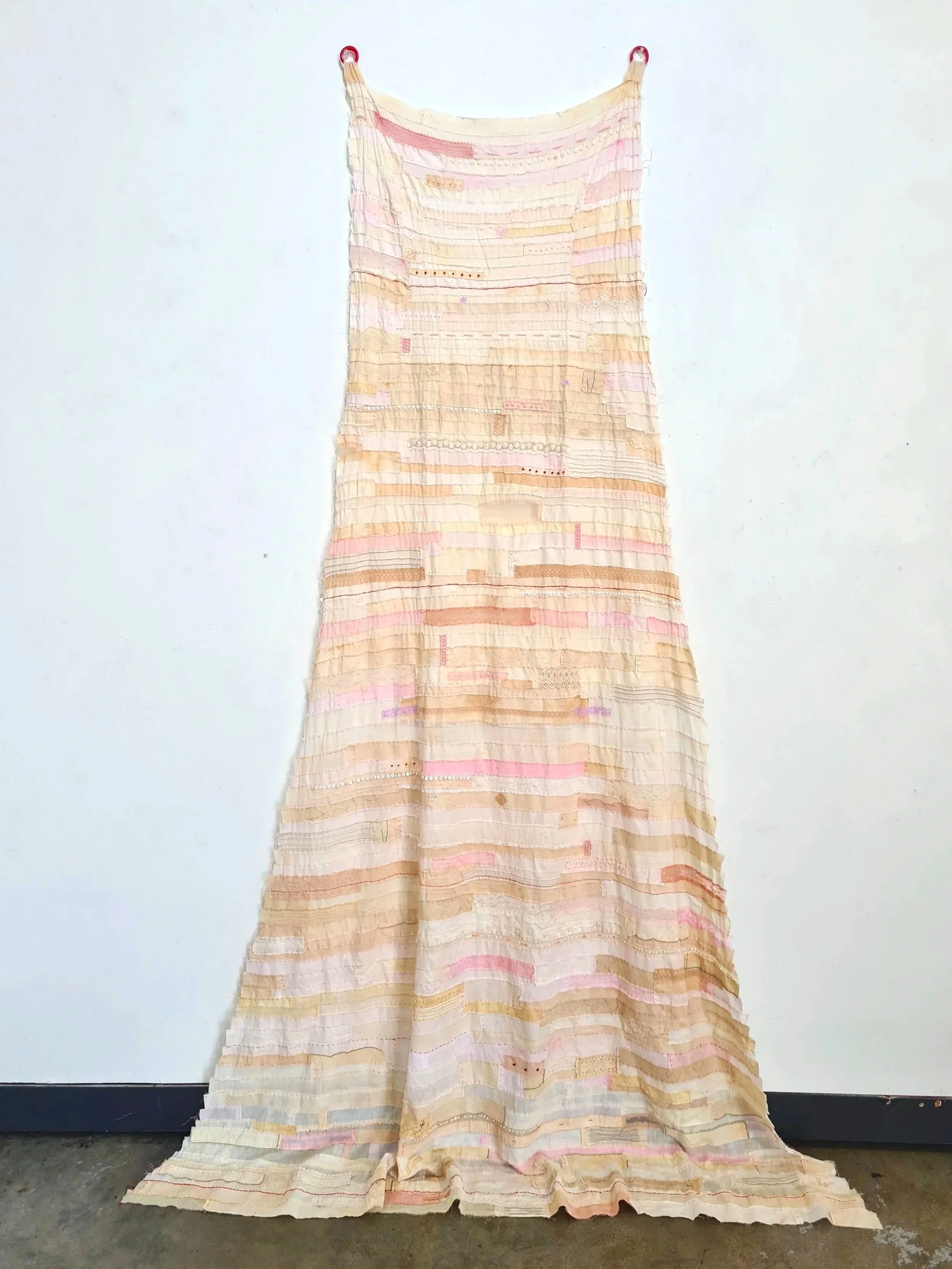 A letter from my heart, 2025-26, fragments of my mothers and my clothes, my mothers lace, found fabrics, beads and deconstructed necklaces, 2.5m x 65cm.
