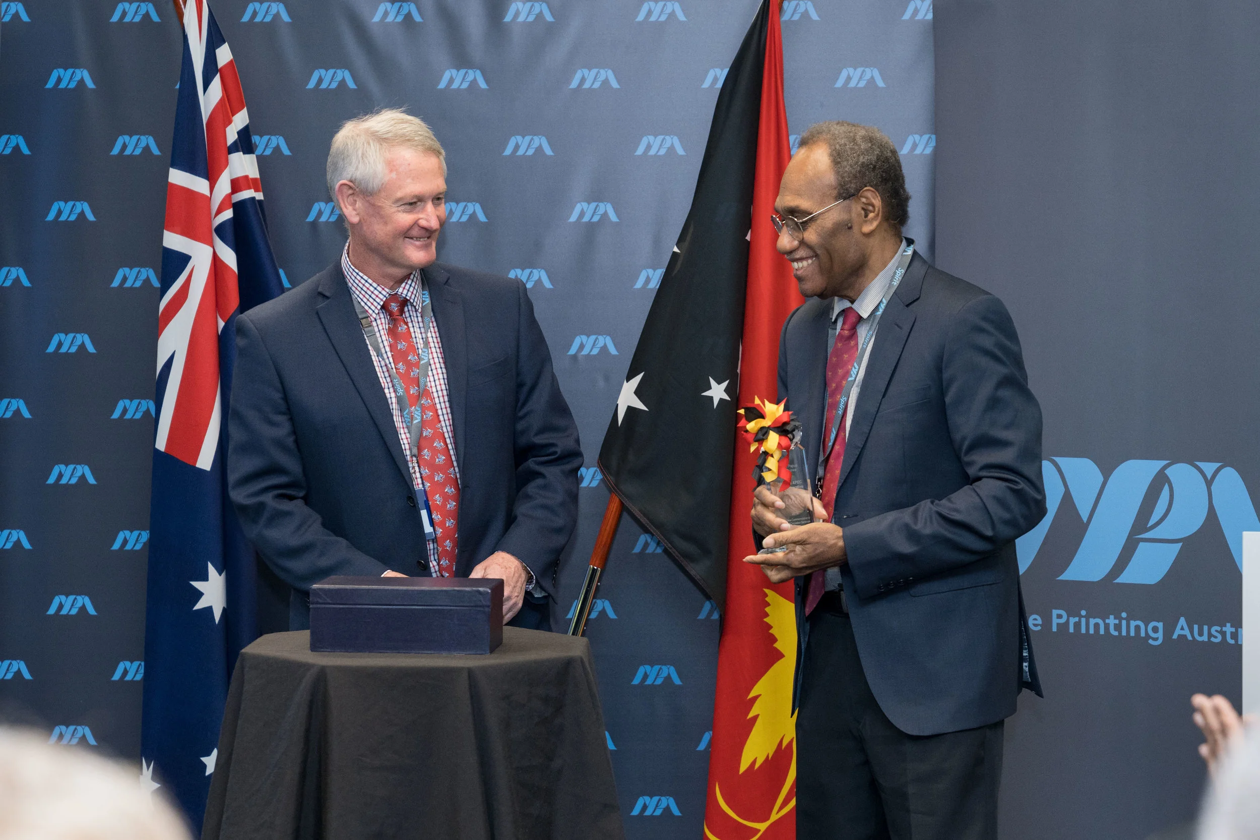 NPA CEO Malcolm McDowell officially presents the IACA Award for Excellence to BPNG Deputy Governor Joe Teria after the nation’s new K100 note was recognised as a Finalist for the Best New Commemorative or Limited Circulation Banknote