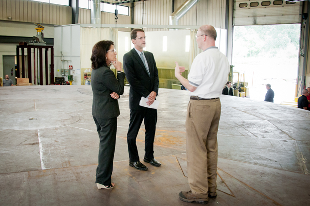 Congressman Himes and Bonnie Del Conte, President/CEO of CONNSTEP, speak with Macton President Peter McGonagle, while atop a rotating turntable for a large military operation.